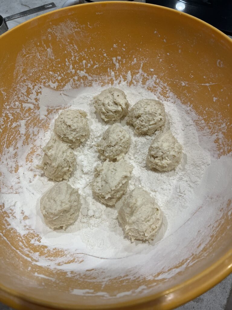 Homemade biscuit dough balls in flour.