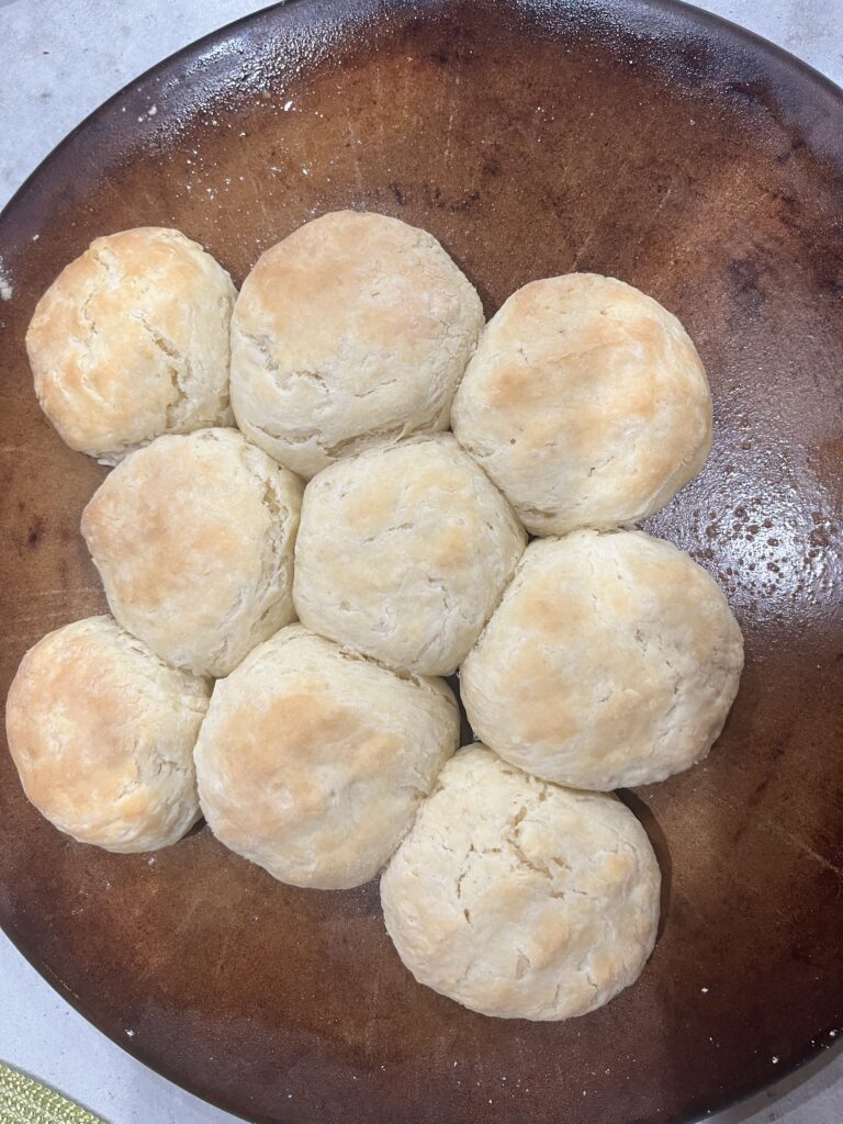 Freshly baked homemade biscuits on a stone baking pan.